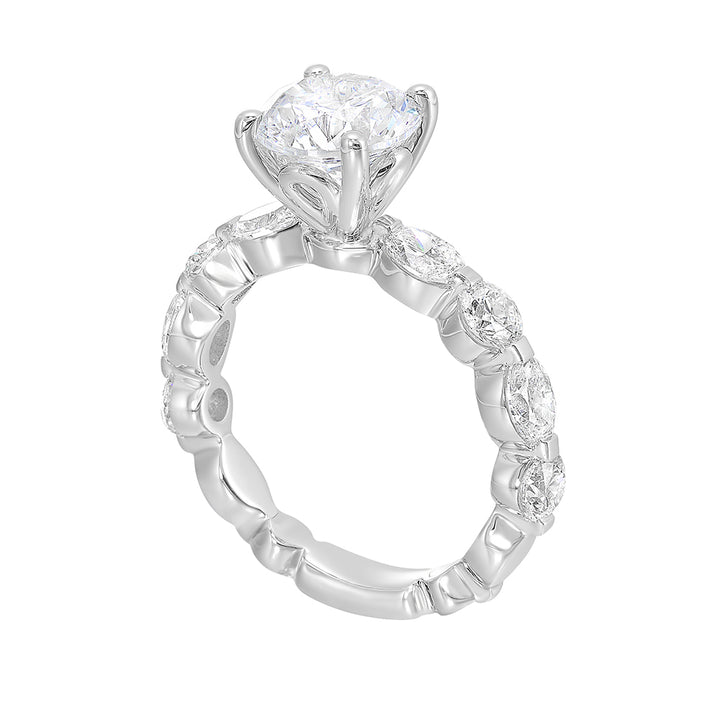 Gorgeous as you marqusie and round diamonds are set alternatively in the shank with round solitaire of this modern engagement ring.