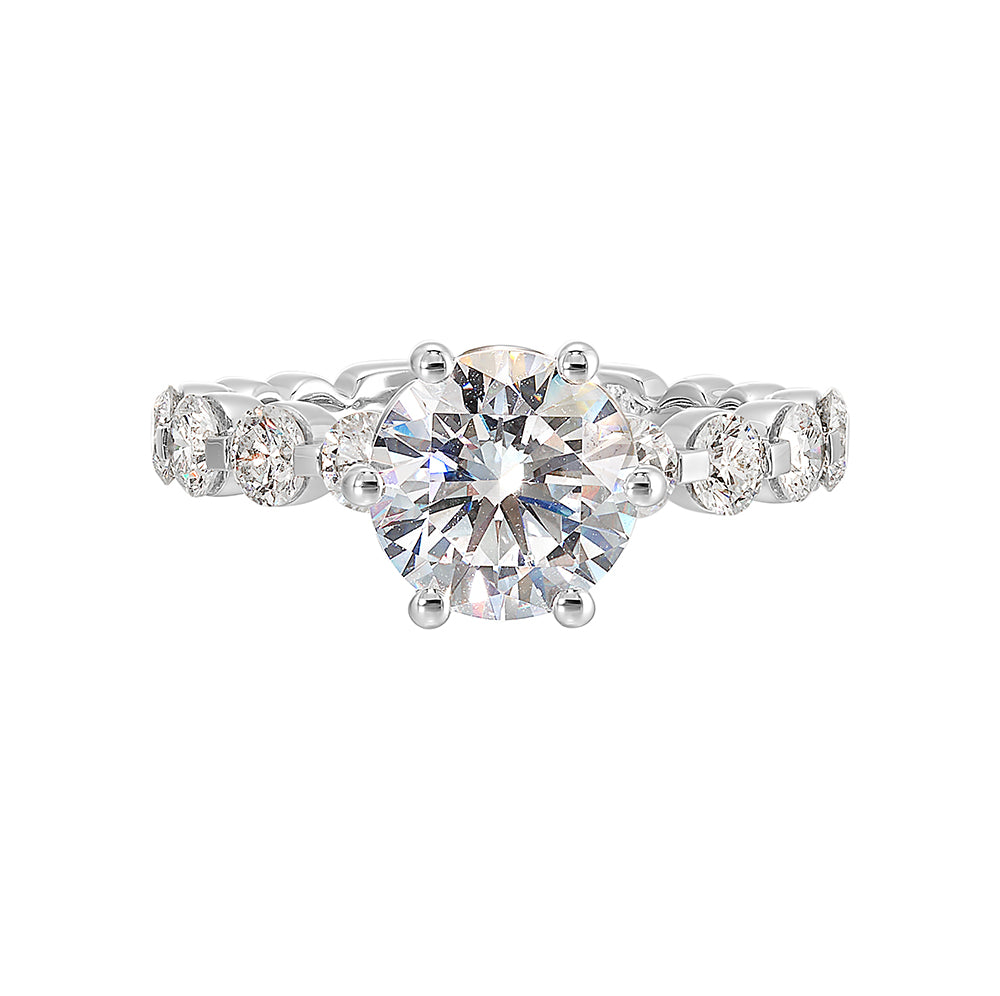 Timeless engagement ring with sparkling 6 prongs round center. Accent diamonds are set along the intricate shank with single prong look.