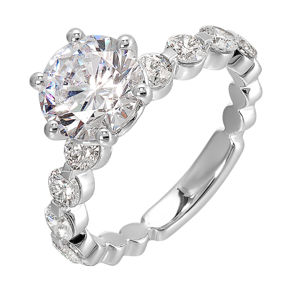 Timeless engagement ring with sparkling 6 prongs round center. Accent diamonds are set along the intricate shank with single prong look.