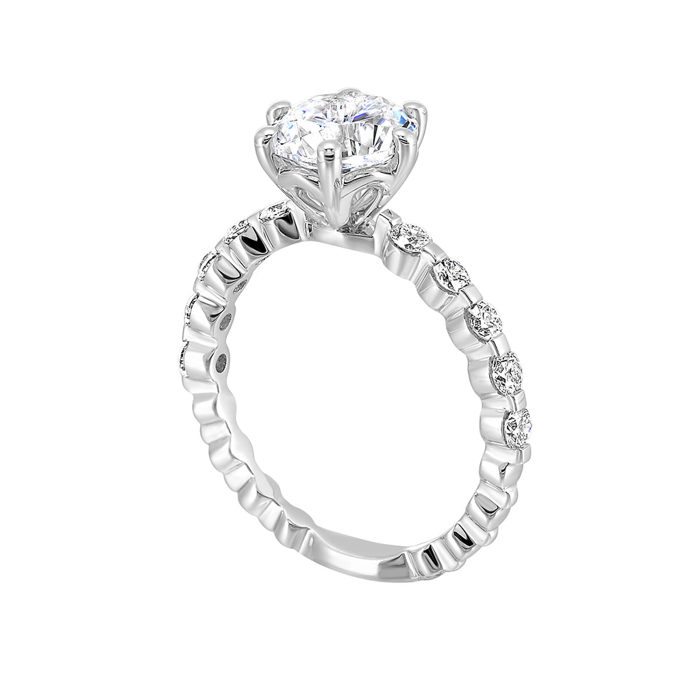 Clean and elegant with diamonds set in a single common prong along the shank shows off perfectly the center diamond set in 6 prong.