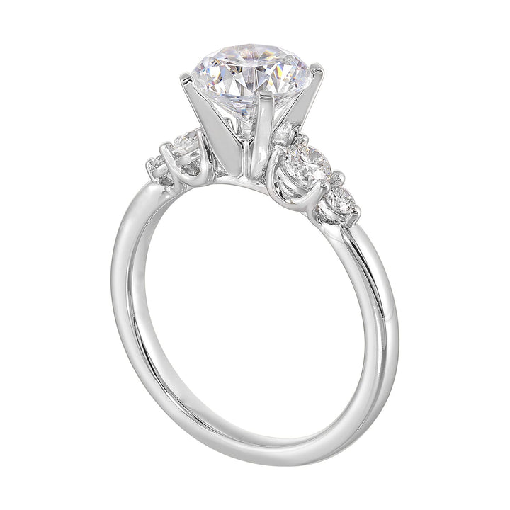 Five times diamonds for five times sparkles. A classic, lustrous band completes the look of this five stone engagement ring.