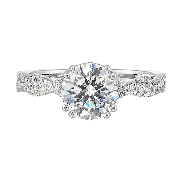 Stunning with a round solitaire diamond set in dual prongs atop a modern crisscross band. The unique twist on timeless elegance is perfect for the modern bride.