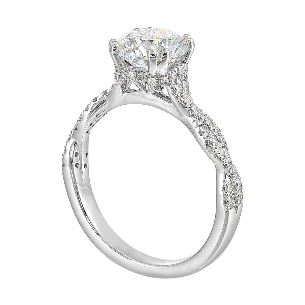Stunning with a round solitaire diamond set in dual prongs atop a modern crisscross band. The unique twist on timeless elegance is perfect for the modern bride.