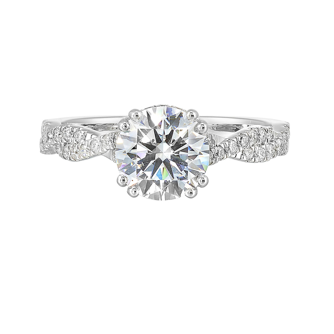 Stunning with a round solitaire diamond set in dual prongs atop a modern crisscross band. The unique twist on timeless elegance is perfect for the modern bride.